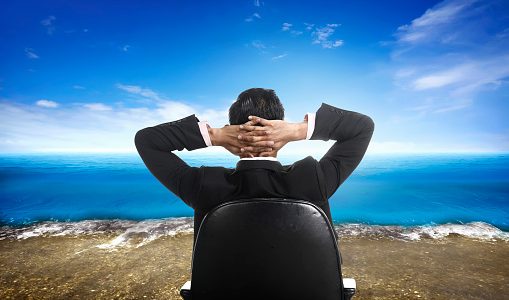 Executive in a desk chair looking out over the ocean.