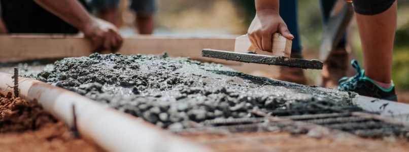 People working on concrete sidewalk build.