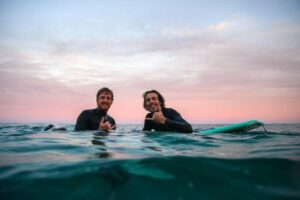 Two men in water on surfboards, Rincon, Puerto Rico