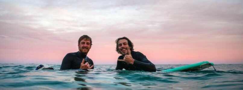 Two men in water on surfboards, Rincon, Puerto Rico