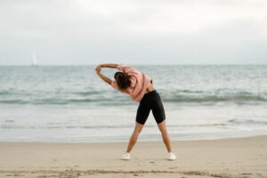 A woman stretching on the beach