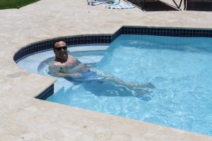Man in swimming pool at Maria's Villa PR