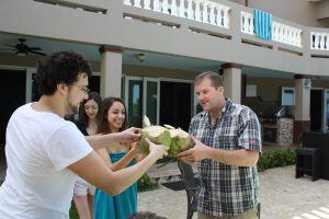 People enjoying coconut milk poolside at Maria's Villa