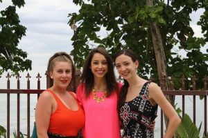 Three women posing in front of Maria's beach, Rincon, PR