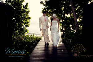 Bride and Groom walking on board walk to Maria's Beach.