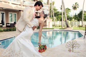 Bride and groom posing in front of swimming pool at Maria's in PR