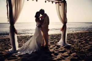 Couple posing under wedding canopy Maria's Beach PR