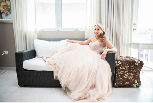 Bride posing on couch at Maria's Villa PR