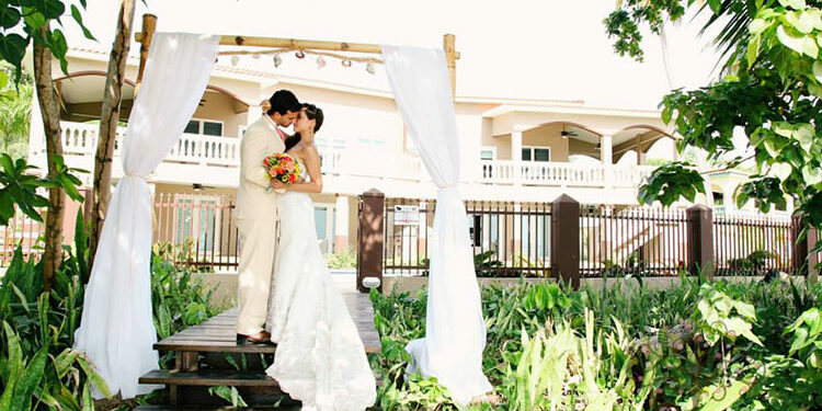 Bride and groom posing at Maria's Villa PR