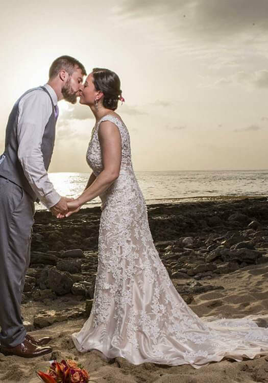 Bride and groom kissing on beach near Maria's Villa in Puerto Rico