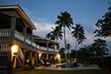 Lado del océano, patio y piscina en la noche